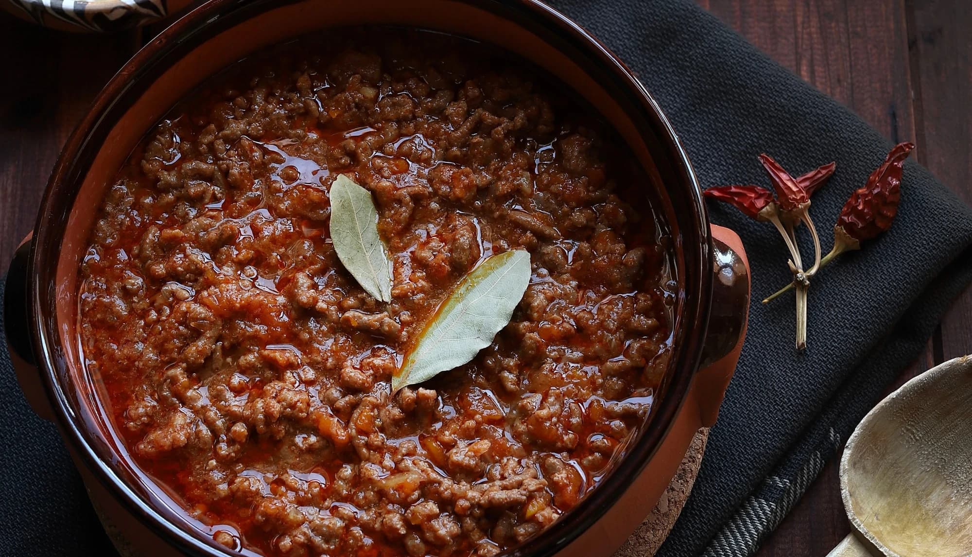 Ragù simmering in a terracotta crock, ready to serve